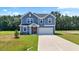 Inviting two-story home featuring a well-manicured lawn, attached garage and classic architectural details at , Fuquay Varina, NC 27526