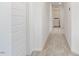 Hallway leading to laundry room with white doors and neutral carpet at , Fuquay Varina, NC 27526