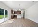 Modern kitchen with stainless steel appliances, island, pendant lighting, and sliding glass doors at , Fuquay Varina, NC 27526