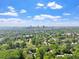 Expansive aerial view showcasing the city skyline nestled amongst lush green trees under a bright, partly cloudy sky at 333 Merrywood Dr, Raleigh, NC 27610