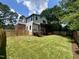 Large backyard featuring a manicured lawn, wooden fence, and the home's rear exterior at 333 Merrywood Dr, Raleigh, NC 27610