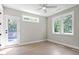 Light-filled bedroom featuring a door to a deck, and many windows with backyard views at 333 Merrywood Dr, Raleigh, NC 27610