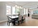 The dining room features a modern chandelier, hardwood floors, neutral paint, and many windows at 333 Merrywood Dr, Raleigh, NC 27610