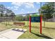 A bench is at the entrance to the Roberts Park Dog Park, along with posted rules and regulations at 333 Merrywood Dr, Raleigh, NC 27610