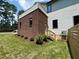 Exterior view featuring a brick section of the house, with a well-maintained lawn and garden at 333 Merrywood Dr, Raleigh, NC 27610