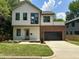 The exterior of the home showcases its siding, windows, landscaping, inviting entrance, and large garage at 333 Merrywood Dr, Raleigh, NC 27610