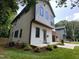 View of the home's exterior, showcasing its siding, windows, landscaping, and inviting entrance and showing the neighboring home at 333 Merrywood Dr, Raleigh, NC 27610