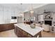 Open layout kitchen and living room with island seating and seamless entertaining space at 333 Merrywood Dr, Raleigh, NC 27610