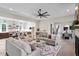 Spacious living room open to the kitchen features an oversized ceiling fan, hardwood floors, and modern decor at 333 Merrywood Dr, Raleigh, NC 27610