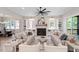 Bright living room features a fireplace, built-in shelving, modern decor, and access to the dining room and outdoor patio at 333 Merrywood Dr, Raleigh, NC 27610