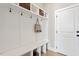 Mudroom featuring a bench, storage cubbies, coat hooks, hardwood floors, and access to the garage at 333 Merrywood Dr, Raleigh, NC 27610