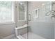 Modern shower stall featuring glass door, tiled walls, and a built-in bench at 333 Merrywood Dr, Raleigh, NC 27610