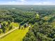 Expansive aerial view of the property with lush greenery, a home, and a winding road at 3701 Oak Grove Church Rd, Mebane, NC 27302
