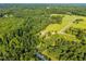 Stunning aerial view of a property nestled among lush greenery and rolling hills at 3701 Oak Grove Church Rd, Mebane, NC 27302
