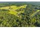 Picturesque aerial shot of a property surrounded by sprawling fields and dense forests at 3701 Oak Grove Church Rd, Mebane, NC 27302