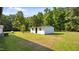 Spacious backyard with a small outbuilding, a propane tank, and mature trees at 3701 Oak Grove Church Rd, Mebane, NC 27302