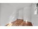 Bright bedroom with hardwood floors and a large window that lets in plenty of natural light at 3701 Oak Grove Church Rd, Mebane, NC 27302