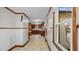 Hallway with view of kitchen featuring white walls with wood trim and neutral floors at 3701 Oak Grove Church Rd, Mebane, NC 27302