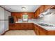 Functional kitchen features wooden cabinets, a double sink, and a cooktop at 3701 Oak Grove Church Rd, Mebane, NC 27302