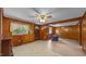 Comfortable living room with wood paneling, a ceiling fan, and openings to other areas at 3701 Oak Grove Church Rd, Mebane, NC 27302