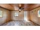Living room with natural wood paneling, ceiling fan, and natural lighting at 3701 Oak Grove Church Rd, Mebane, NC 27302