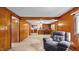 Spacious living area with wood paneling, a brick accent wall, and an open layout at 3701 Oak Grove Church Rd, Mebane, NC 27302