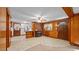 Cozy living room with a brick fireplace, wood paneling, and a ceiling fan at 3701 Oak Grove Church Rd, Mebane, NC 27302