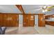 Spacious living room featuring wood paneling and openings to the kitchen and other rooms at 3701 Oak Grove Church Rd, Mebane, NC 27302