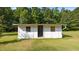 Exterior view of a white-painted shed, offering potential for storage or workshop space at 3701 Oak Grove Church Rd, Mebane, NC 27302