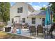 This backyard has a hot tub, grill, outdoor dining set, and a door that leads inside the house at 3814 Tyler Bluff Ln, Raleigh, NC 27616