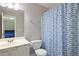 Clean bathroom with patterned shower curtain adjacent to the main bedroom at 3814 Tyler Bluff Ln, Raleigh, NC 27616