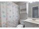 Bathroom with a shower curtain with sea stars and shells, a white toilet and a vanity cabinet at 3814 Tyler Bluff Ln, Raleigh, NC 27616