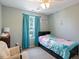 Bright bedroom with a ceiling fan and large window with blue curtains at 3814 Tyler Bluff Ln, Raleigh, NC 27616
