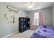 This bedroom has a ceiling fan, a window with pink curtains, and a decorative bookshelf with storage containers at 3814 Tyler Bluff Ln, Raleigh, NC 27616