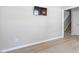 Bright living room with wood floors featuring a wall-mounted television at 3814 Tyler Bluff Ln, Raleigh, NC 27616