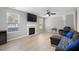 Comfortable living room with a fireplace, TV, and lots of natural light at 3814 Tyler Bluff Ln, Raleigh, NC 27616