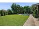 Large backyard with manicured lawn and a pool at 39 Wood Stork Ct, Clayton, NC 27520