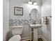 Powder room with pedestal sink, decorative mirror and toilet at 39 Wood Stork Ct, Clayton, NC 27520