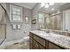 Gray bathroom with a granite countertop, tiled shower and window at 39 Wood Stork Ct, Clayton, NC 27520