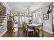 Bright dining room featuring a chandelier, hardwood floors, and large windows with shutters at 39 Wood Stork Ct, Clayton, NC 27520