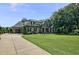 Stately home with a large driveway and a well-maintained lawn, showcasing classic design at 39 Wood Stork Ct, Clayton, NC 27520