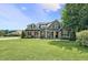 Charming brick home with manicured lawn, professional landscaping, and inviting front porch at 39 Wood Stork Ct, Clayton, NC 27520