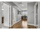 Bright hallway with hardwood floors leading to rooms and an office with natural light at 39 Wood Stork Ct, Clayton, NC 27520