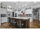 Modern kitchen featuring a large island with seating, pendant lights, and stainless steel appliances at 39 Wood Stork Ct, Clayton, NC 27520