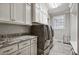 Functional laundry room with granite countertops, ample cabinet space and modern washer/dryer units at 39 Wood Stork Ct, Clayton, NC 27520