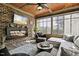 Inviting sunroom boasts brick walls, wood ceiling, electric fireplace, and large windows at 39 Wood Stork Ct, Clayton, NC 27520
