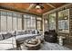 Bright sunroom boasting brick walls, wood ceiling, and large windows at 39 Wood Stork Ct, Clayton, NC 27520