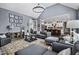 Open-concept living room with stylish furniture, hardwood floors, and seamless flow to the kitchen at 39 Wood Stork Ct, Clayton, NC 27520