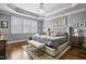 Luxurious main bedroom with tray ceilings, chandelier, shuttered windows, and tufted headboard at 39 Wood Stork Ct, Clayton, NC 27520