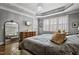 Comfortable main bedroom with a large mirror and windows providing ample natural light at 39 Wood Stork Ct, Clayton, NC 27520